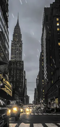 This stunning live wallpaper for your phone features an evening scene of a busy city street flanked by tall buildings