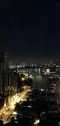 The phone live wallpaper depicts an aerial view of Manila at night