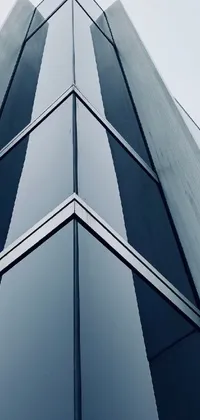 This live phone wallpaper showcases an impressive tall building with plenty of windows, set against a grey warehouse backdrop