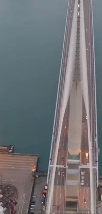 This phone live wallpaper features an aerial view of a bridge over a body of water