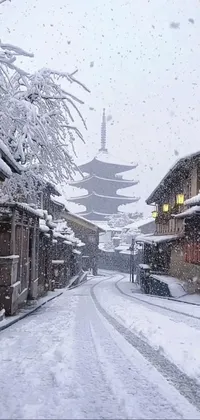 This phone live wallpaper depicts a stunning winter scene with falling snowflakes and a pagoda in the background