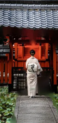 This Japanese-themed phone live wallpaper displays a woman in a kimono standing facing a red building