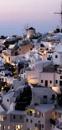 This phone live wallpaper showcases a charming Mediterranean fisher village atop a hill in Santorini, Greece