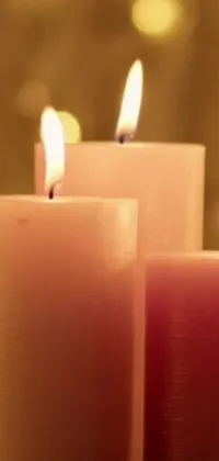 This live wallpaper features three delicate candles illuminating a table with their gentle flickering flame