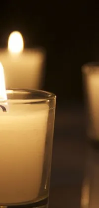 This stunning live wallpaper for your phone features a serene and calming scene of candles