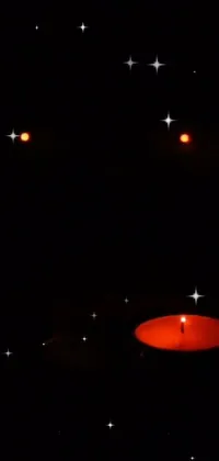 This phone live wallpaper depicts a lit candle in the dark, creating a warm and cozy atmosphere