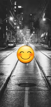 This phone live wallpaper boasts a captivating black and white photo of a smiley face found on a rainy city street