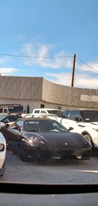 Looking for a captivating live wallpaper that showcases the luxury and extravagance of Las Vegas? Look no further than this dazzling image of a parking lot filled with high-end exotic cars, all arranged in neat rows and columns