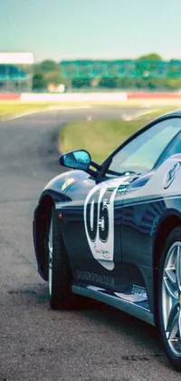 This dynamic phone live wallpaper showcases a stunning blue sports car racing down a track with a number on its side and front