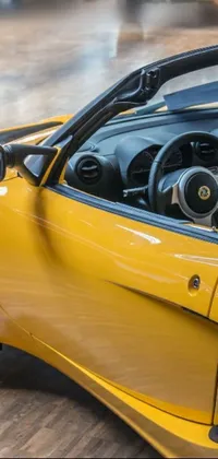 This live wallpaper features a yellow sports car with a black top, steering wheel, and dashboard