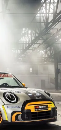 This phone live wallpaper showcases a photorealistic Mini Cooper S parked in a garage
