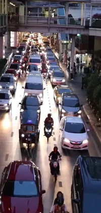 Get a stunning live wallpaper featuring a busy city street filled with traffic for your phone