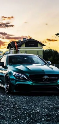 Discover a stunning live wallpaper featuring a sleek green car parked in front of an elegant house
