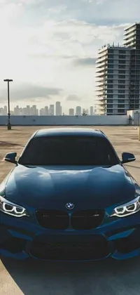 This live wallpaper features a blue BMW car parked in a lot, providing a symmetrical and visually appealing front view