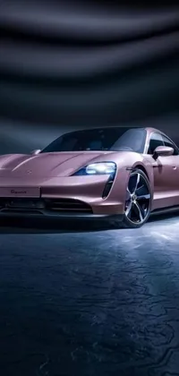 This live phone wallpaper features a pink sports car in a dark room