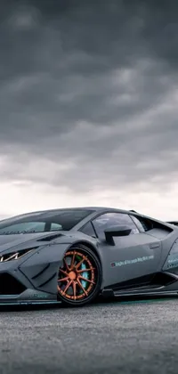 This stunning phone live wallpaper showcases a grey and orange sports car parked in a parking lot
