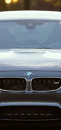 This live wallpaper for your phone features a high-resolution image of a black BMW parked on the side of a road