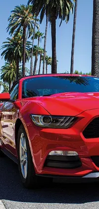This phone live wallpaper features an ultra wide-shot picture of a red mustang parked on the side of a road in Los Angeles, near the beach