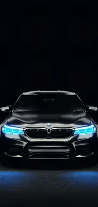 Introducing a sleek 4k vertical phone wallpaper that features a hologram of a BMW concept car in a dark room