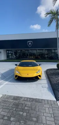 This live wallpaper showcases a striking yellow sports car parked in front of a building