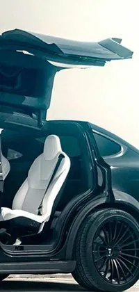 This live wallpaper features an impressive black Tesla SUV with open doors