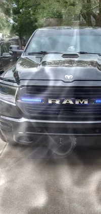 This live wallpaper features a black Ram truck with holographic accents parked in a dimly lit parking lot