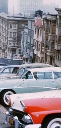 This phone live wallpaper showcases a row of classic cars parked on a street in San Francisco, capturing the retro futurism aesthetic of the 1950s
