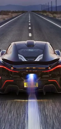 This live wallpaper for phones features a sleek black sports car driving down a road, creating a majestic and futuristic ambiance