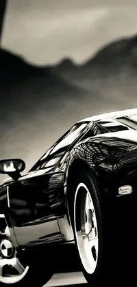 This dynamic phone live wallpaper features a black and white photo of a glossy sports car, set against a blurred, high-contrast background