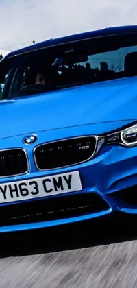 This captivating live wallpaper features a blue BMW car cruising down a city road, with colourful lights following behind