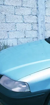This live wallpaper features a vintage blue car with a roof rack parked next to a brick wall