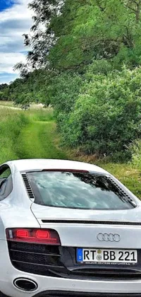 Enjoy an amazing live wallpaper of a white sports car speeding along a scenic country road