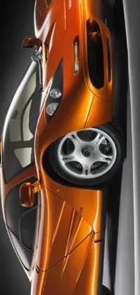Get revved up with this dynamic phone live wallpaper featuring an orange sports car perched atop a wall