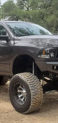 Looking for a dynamic live wallpaper? Look no further than this amazing black truck on a dirt field! Its towering ram antlers, combined with its gun metal grey finish and custom headlights, all combine to create an impressive sight
