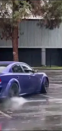 This live phone wallpaper features a blue car driving on a wet parking lot
