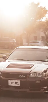 This live wallpaper showcases a modified Nissan Skyline R34 parked by the side of a road