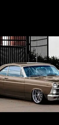 This live wallpaper showcases a vintage brown Ford parked in front of a building