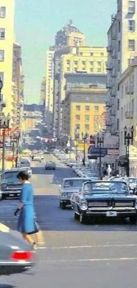 This beautiful live wallpaper features a vintage colorized photograph of a woman in a blue dress crossing a busy city street against a backdrop of classic cars in San Francisco