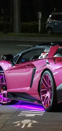 This live phone wallpaper shows a pink sports car parked at night with stars in the sky