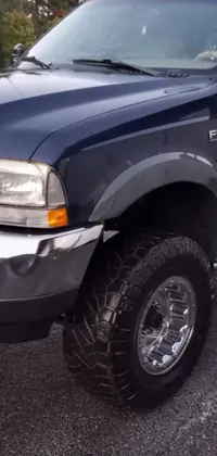 This phone live wallpaper features a highly-detailed blue truck parked in a lot