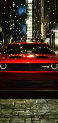 Looking for a dynamic new look for your phone that packs some serious speed and style? Check out this striking live wallpaper! Featuring a powerful, Mopar model car cruising down a busy city street at night, this wallpaper is sure to turn heads with its bold, front-lit lights and intense, 'angry' headlight design