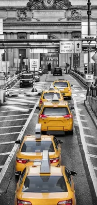 This phone live wallpaper features a stunning black and white photograph of taxi cabs on a city street, creating an immersive urban environment on your screen