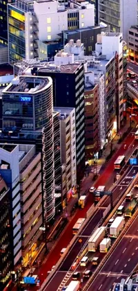 This phone live wallpaper features a stunning aerial view of a modern Tokyo street, complete with towering skyscrapers and heavy traffic flowing along a bustling freeway