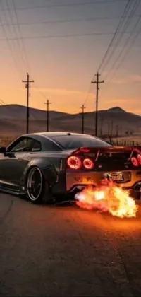 If you're looking for a thrilling live wallpaper for your phone, this image of a Nissan GTR R 3 4 with flames shooting out from its body is perfect for you! Designed with a unique and intriguing visual style, this cinematic view captures the essence of speed and adrenaline