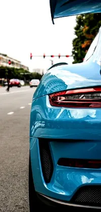 Get mesmerized with the stunning live wallpaper of a blue 4k photorealistic sports car parked on the side of the road