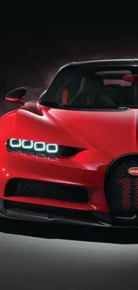 This phone live wallpaper features a hyper-realistic red sports car graphic designed with ultra-detail & lights on, against a black background