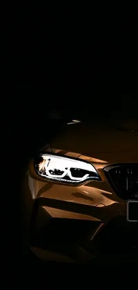 This phone wallpaper boasts an eye-catching digital art image of a BMW car up close in the darkness