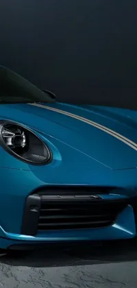 Looking for a sleek and stylish live wallpaper for your phone? Check out this stunning image of a blue sports car parked in a garage