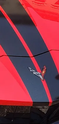 This live wallpaper features a stunning close-up of a hood of a fierce, red sports car
