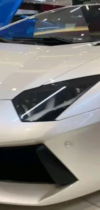 Experience the breathtaking beauty of a white sports car parked in a showroom as your phone live wallpaper
